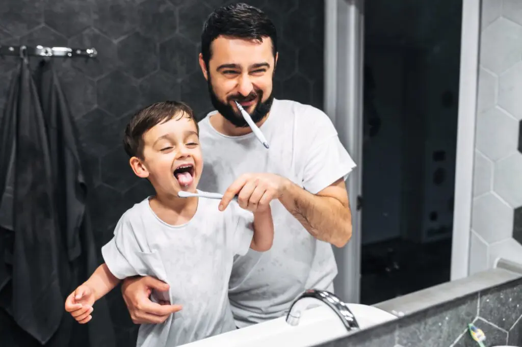 Father teaching his child the proper tooth-brushing technique