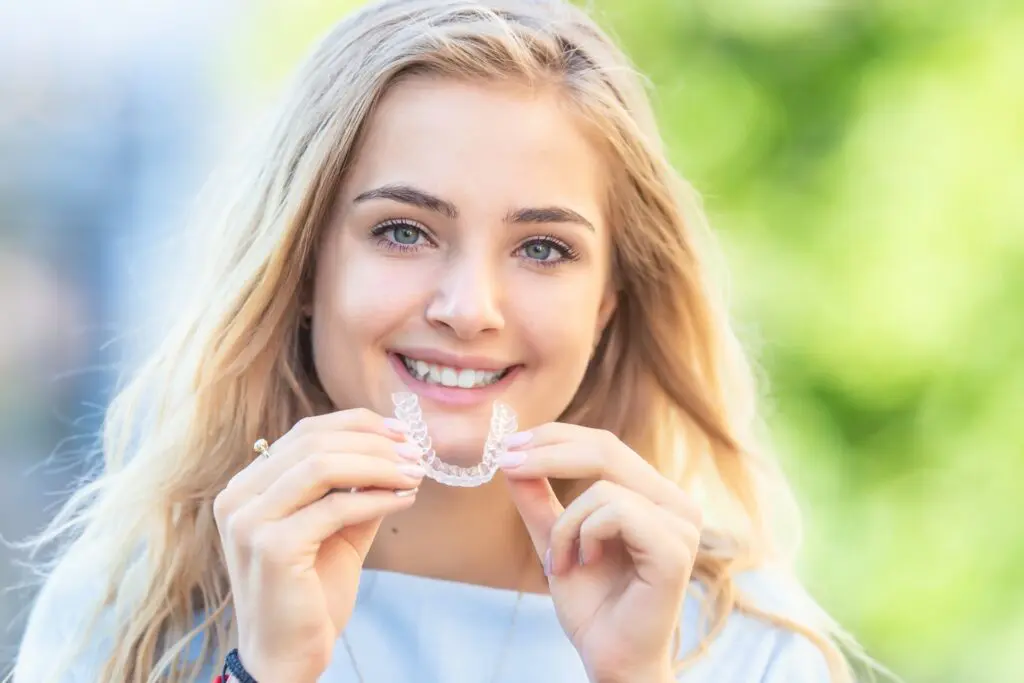 Teen girl using Invisalign to straighten teeth in Kelowna
