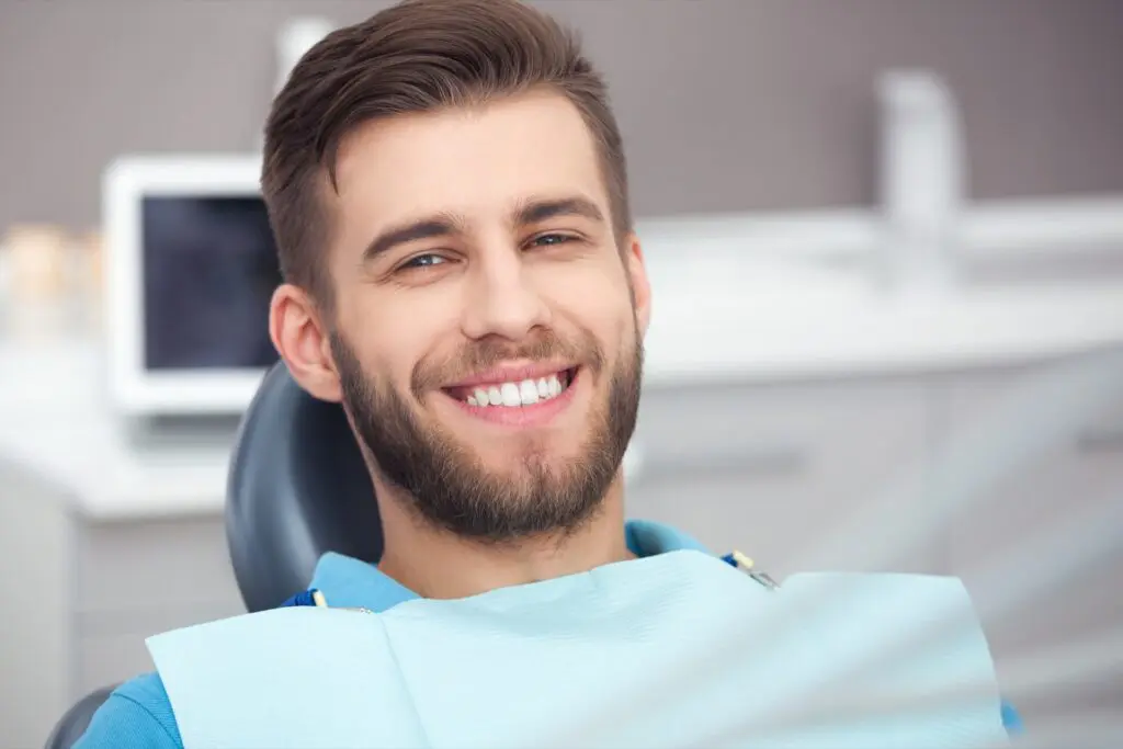 Happy man after dental check-up and teeth whitening