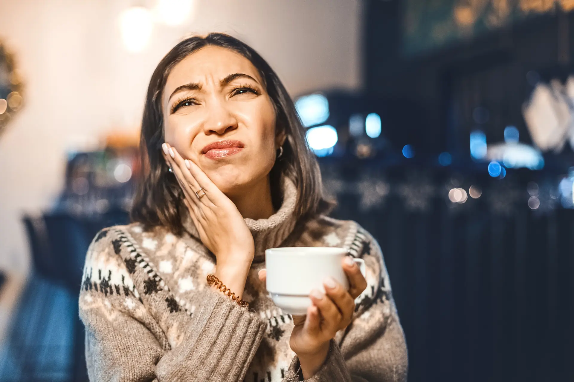 Woman experiencing tooth sensitivity