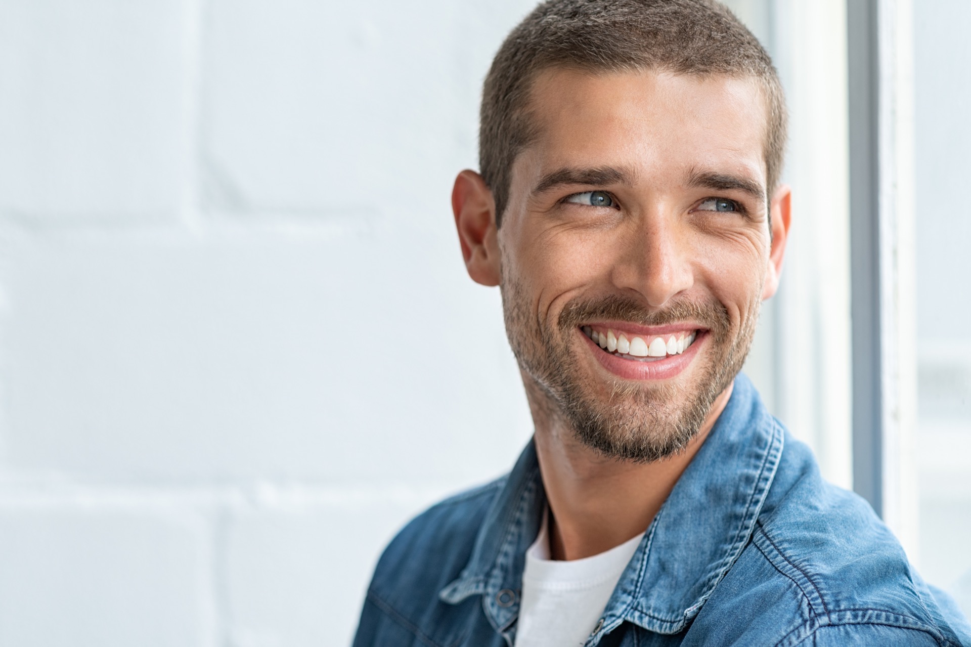 Smiling man happy after seeing teeth whitening dentist