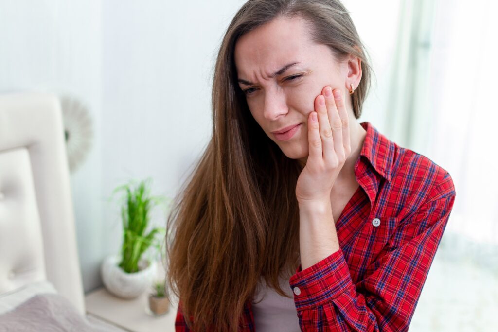 Young woman suffering from teeth grinding
