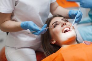 Dentist helping patient experiencing dental anxiety stay calm