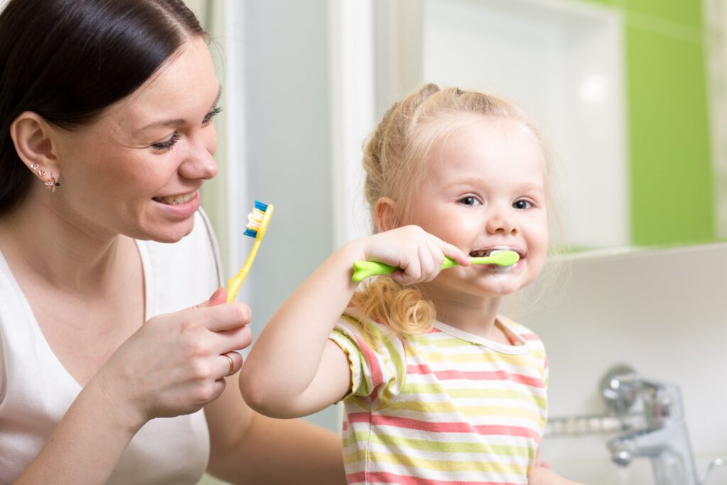 Child learning to brush teeth