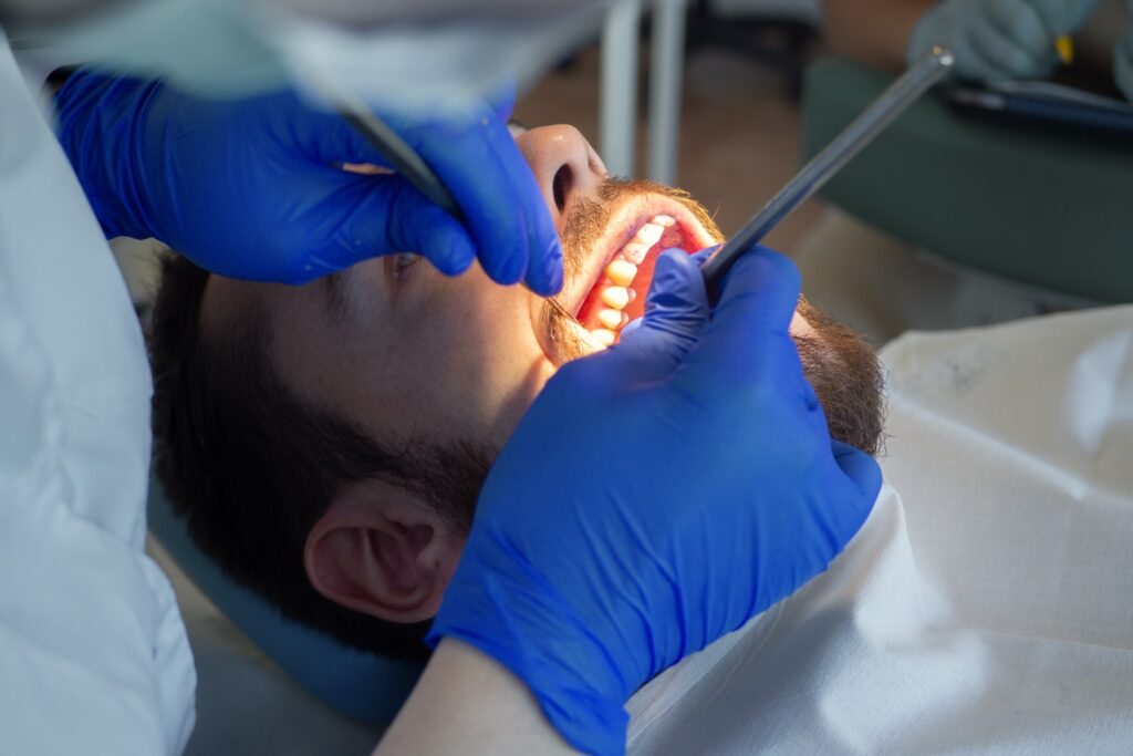 Man having teeth professional cleaned by dentist