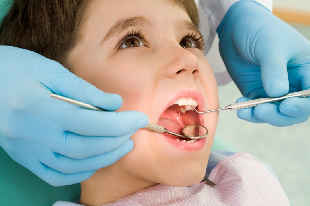 Child getting dental exam to check for cavities