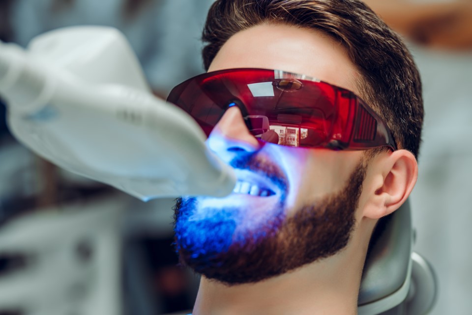 Man having teeth whitened at dentist