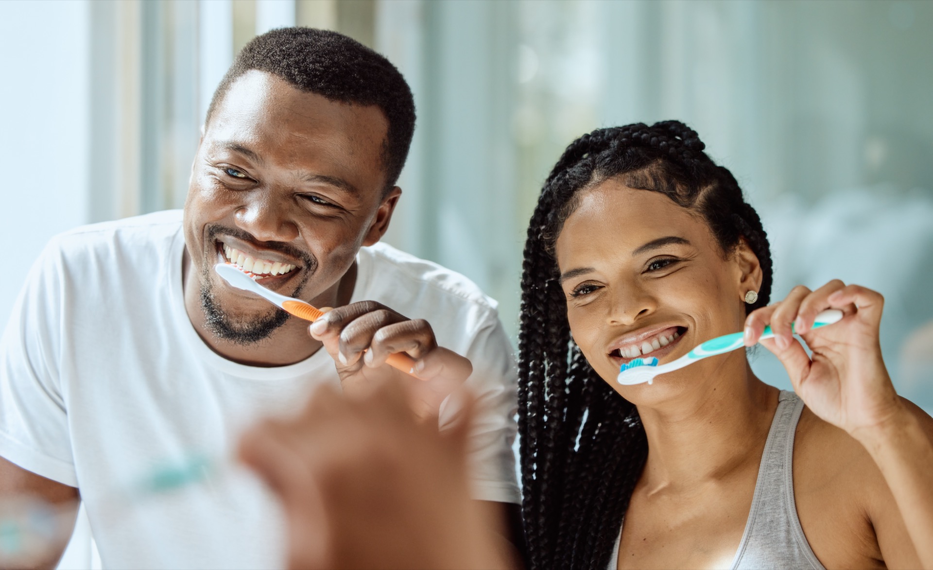 Couple improving oral health with good oral health routine